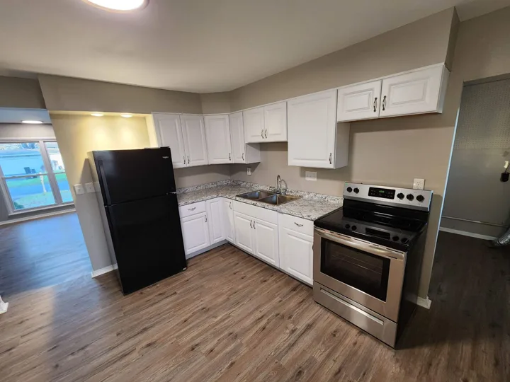 Fixr-Up: Kitchen with white cabinetry, backsplash and updated flooring